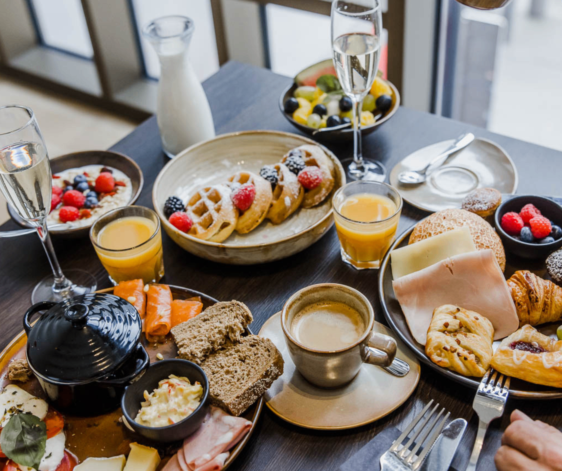 Extensive breakfast with fresh waffles, viennoiserie, charcuterie, fruit and cava at Corsendonk Turnova