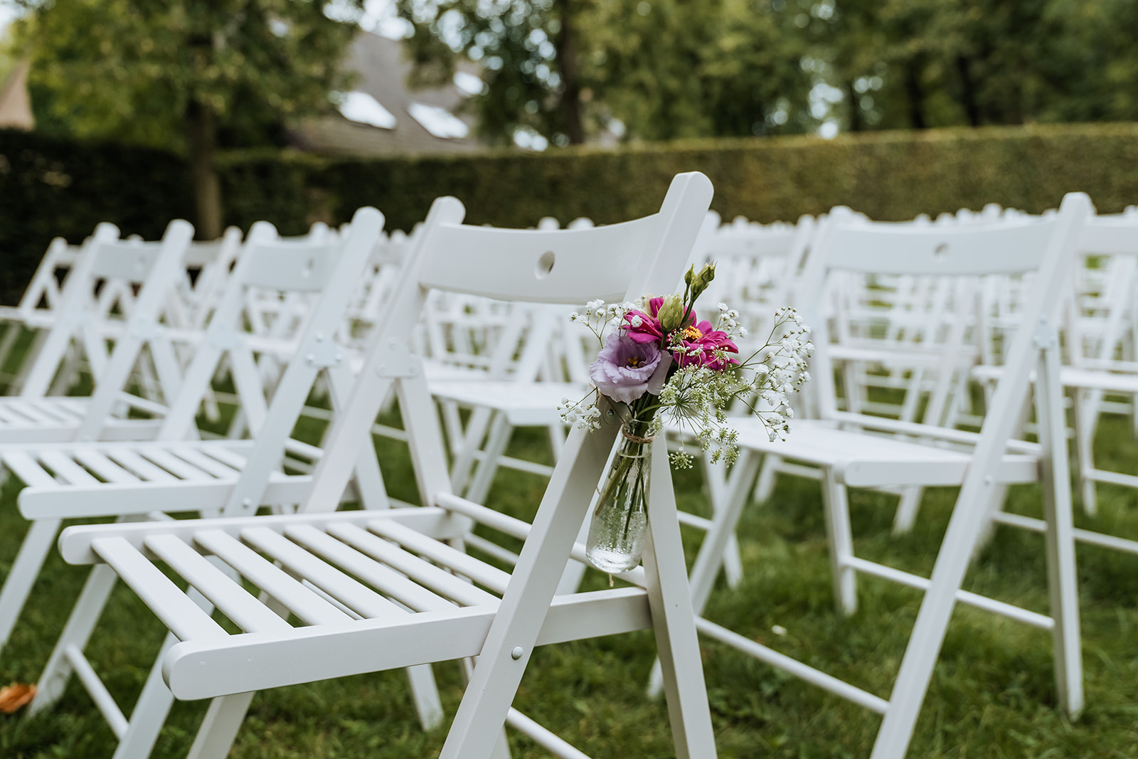 White ceremony chair with field bouquet