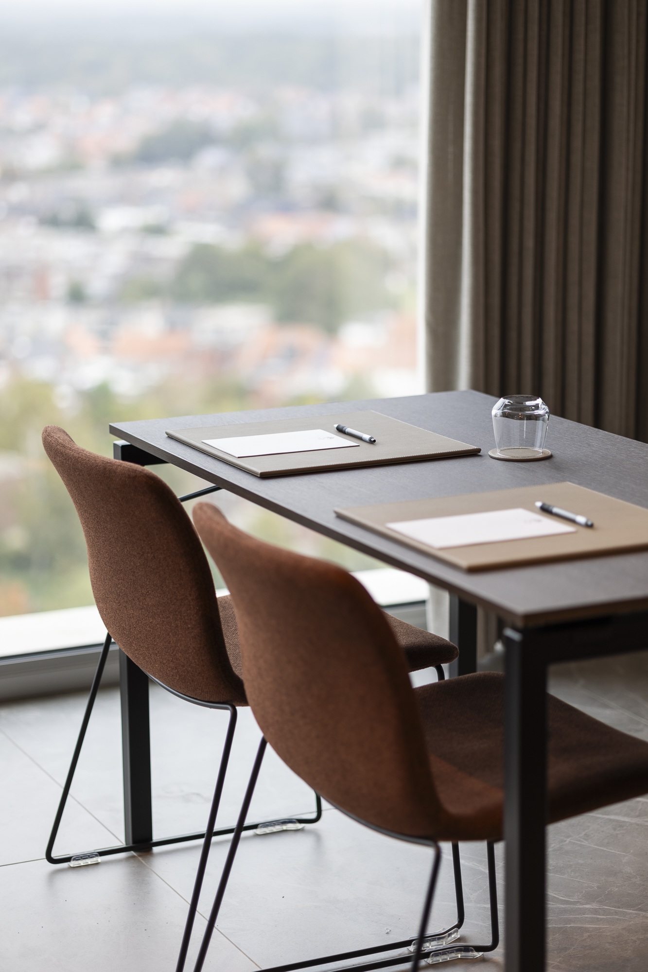 Meeting table with notepad and pen by the panoramic window at Sky Venue