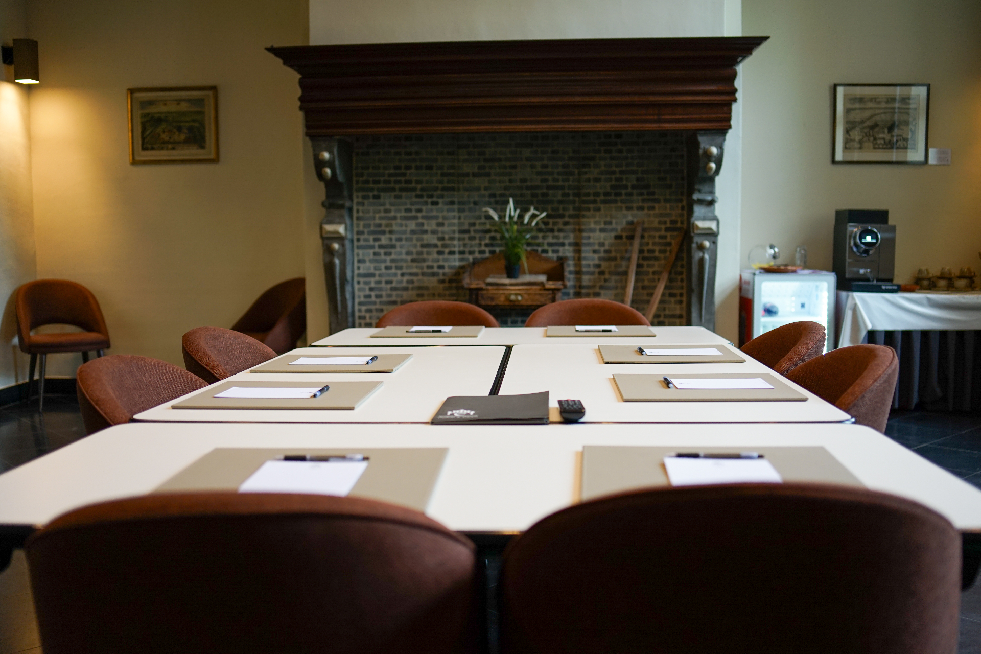 Meeting table set up near a historic mantelpiece in a Priorij Corsendonk meeting room