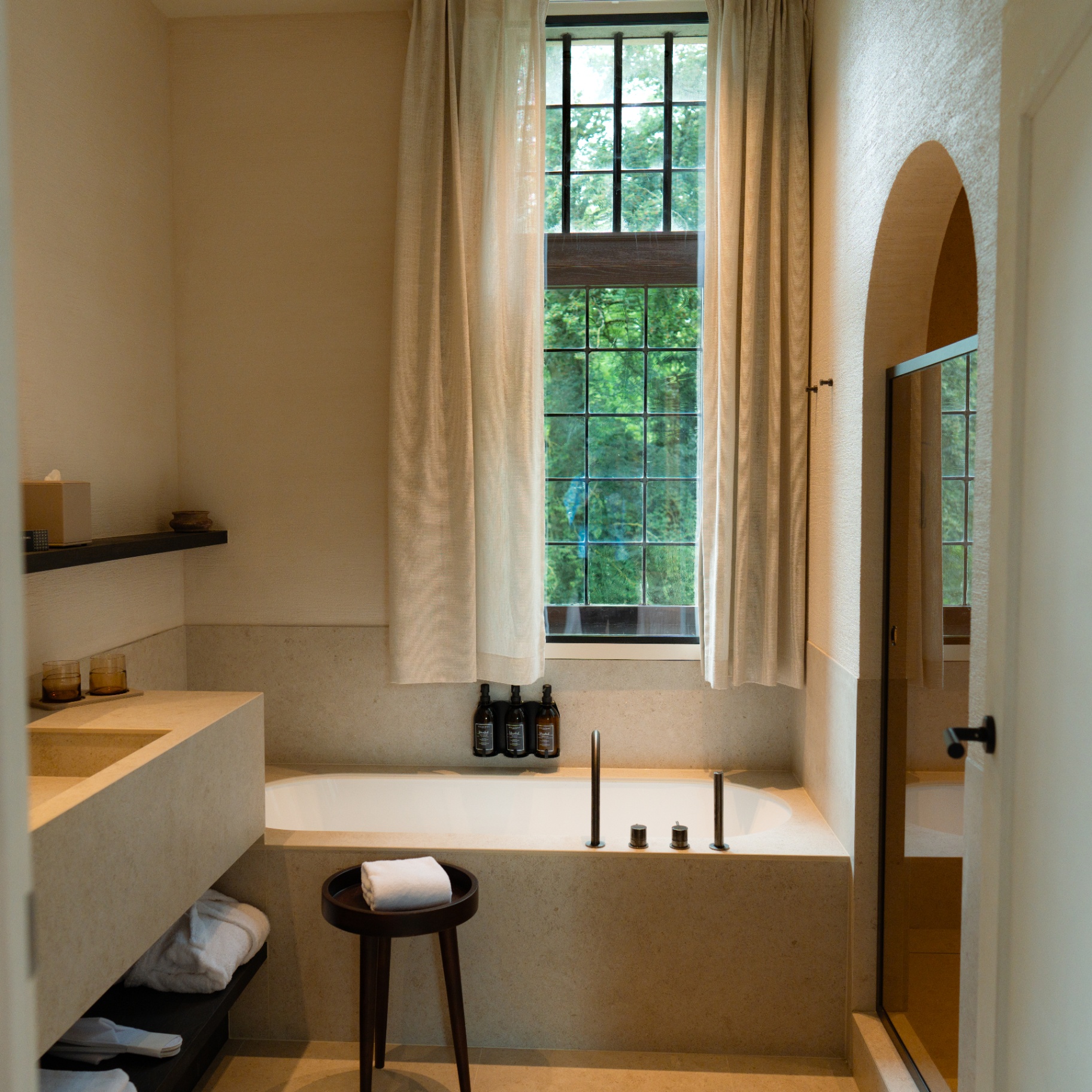 Atmospheric bathroom with natural light in a guest room of Priorij Corsendonk