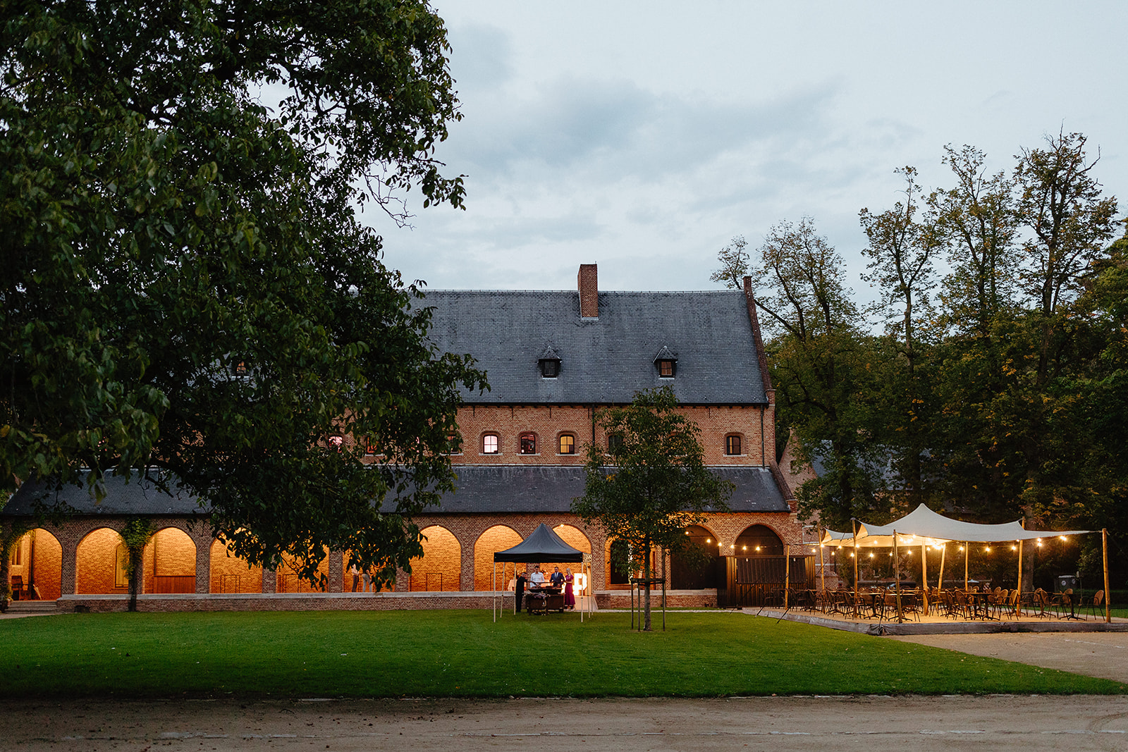 Priorij in evening light with stretch tent