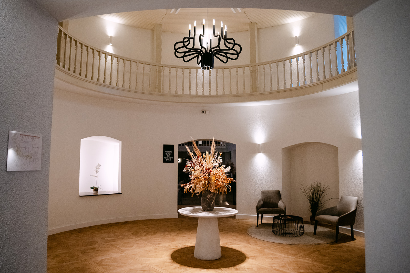 Atmospheric lobby with chandelier at Corsendonk Hooge Heyde