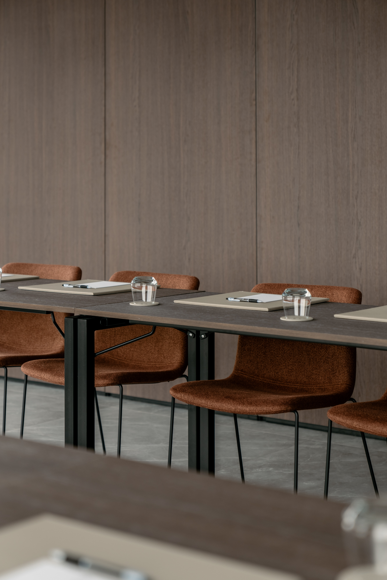 Meeting tables with notepads and water glasses at Sky Venue