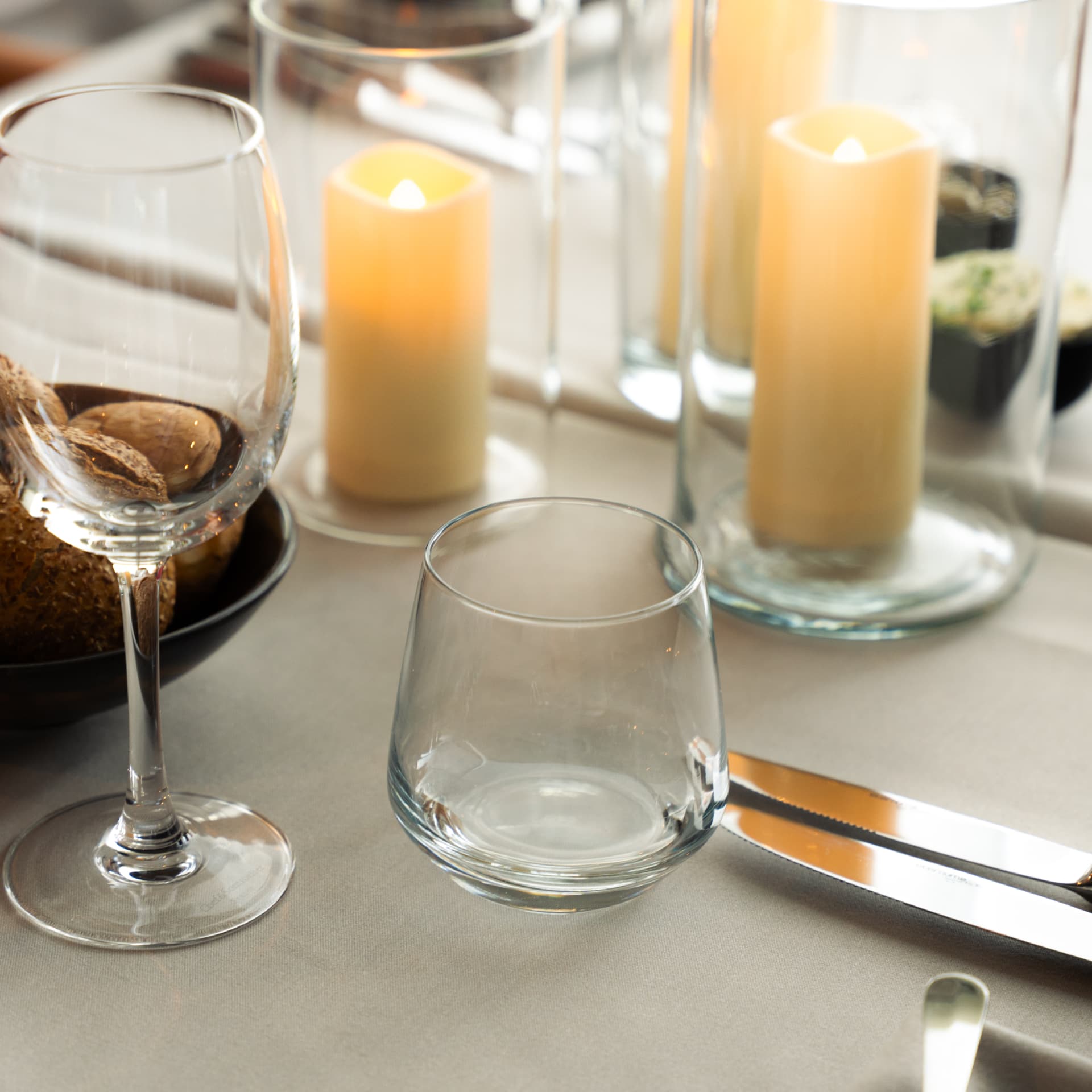 Set table with candlelight, wine glasses and bread at Sky Venue