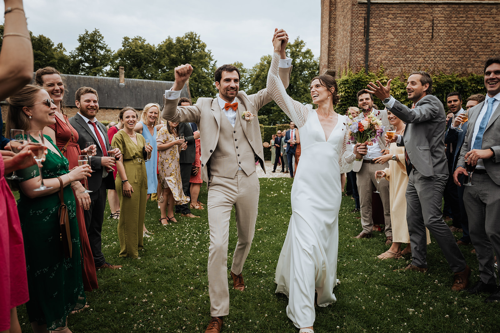 Cheering bridal couple among the guests