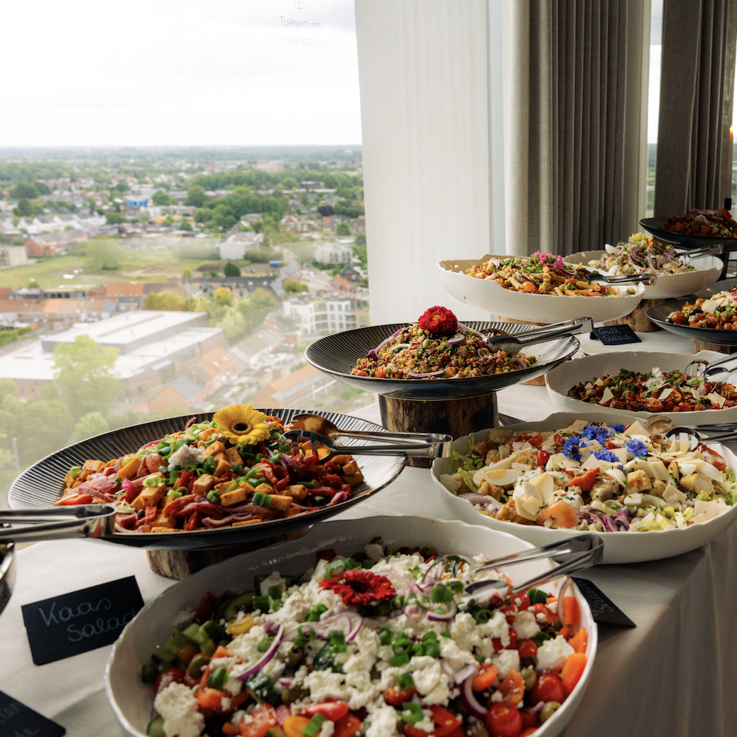 Rich brunch buffet with colorful salads and panoramic views over Turnhout at Sky Venue