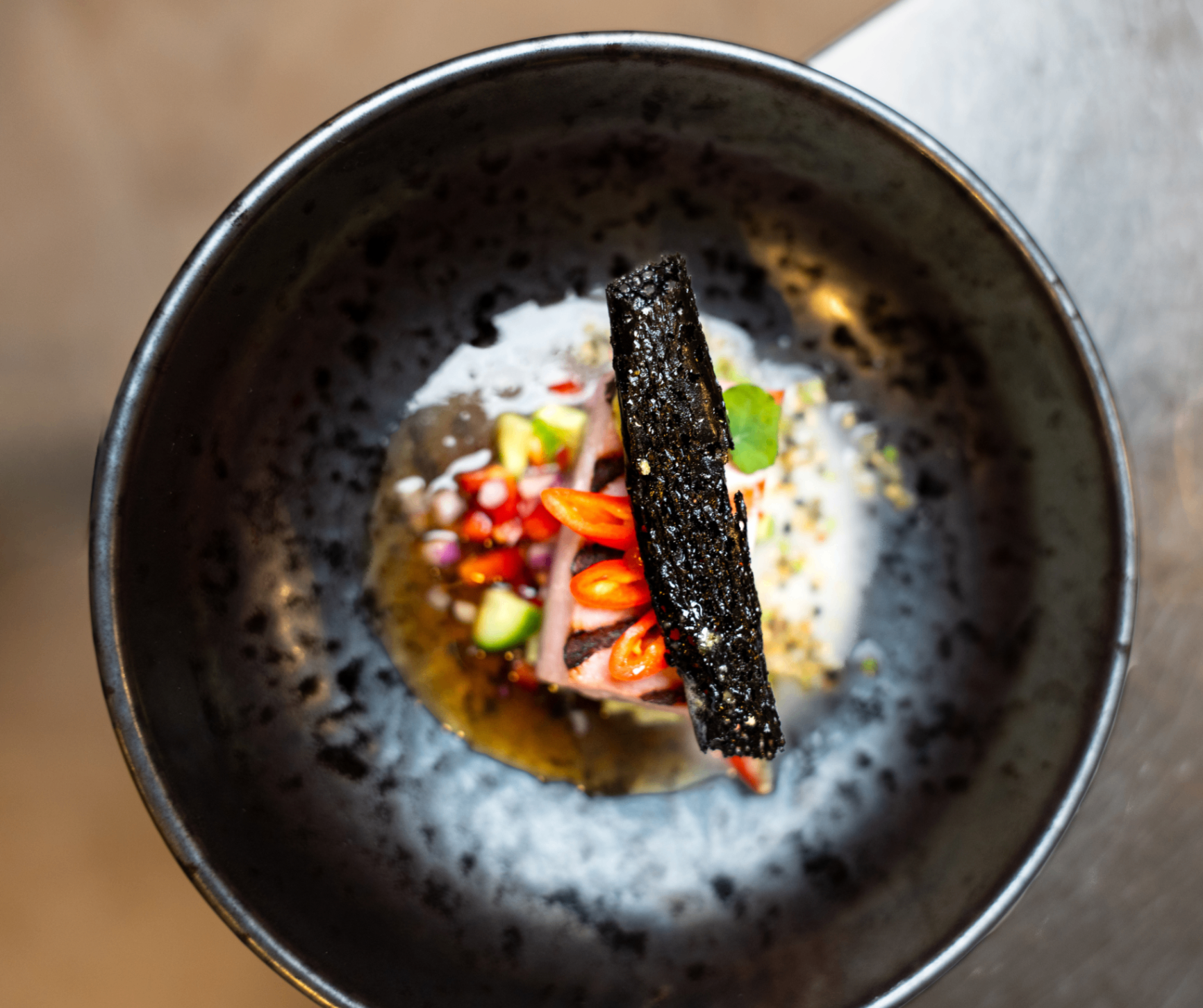 Refined dish on black earthenware from the kitchen of Corsendonk Hooge Heyde