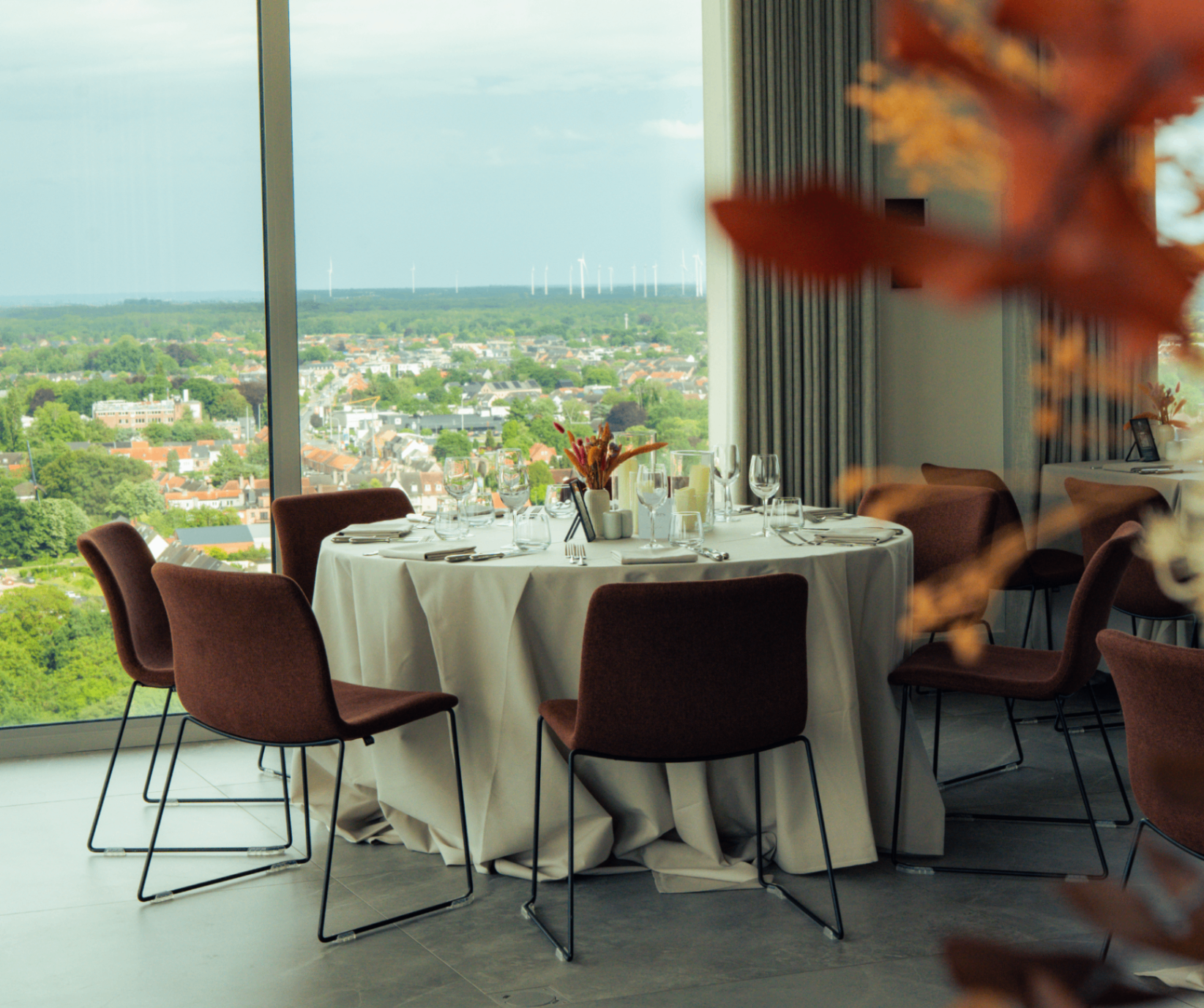 Festively set round table with panoramic view over Turnhout at Sky Nights
