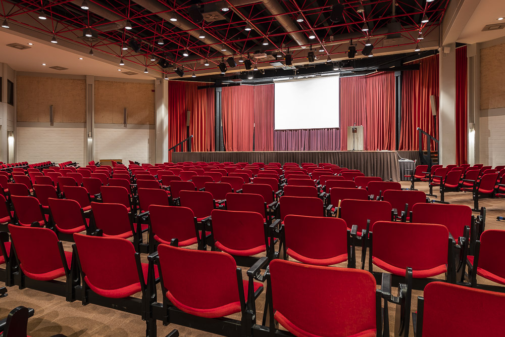 Concert hall with stage and red seats