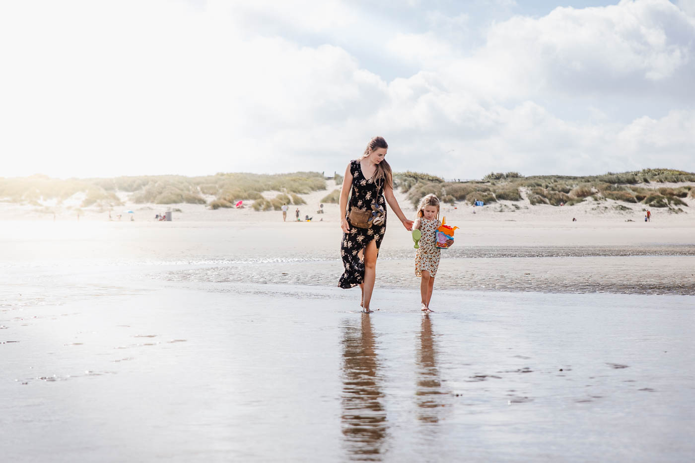 Mother and daughter walking on the beach at Duinse Polders